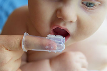 Infant Getting Teeth Brushed Image